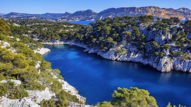 Vue d’un lac entouré de montagnes verdoyantes